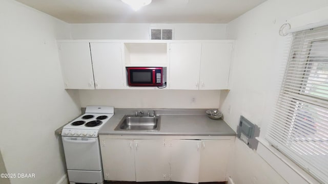 kitchen with white cabinetry, white range with electric stovetop, and sink