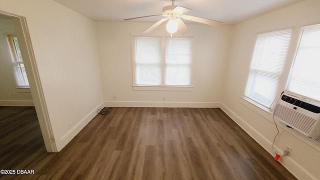 spare room featuring plenty of natural light, ceiling fan, and dark hardwood / wood-style flooring