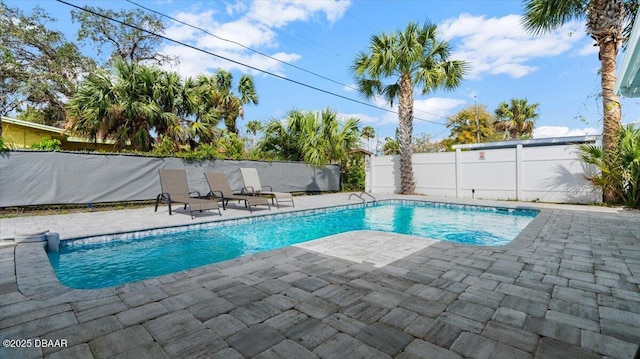 view of swimming pool featuring a fenced in pool, a patio, and fence