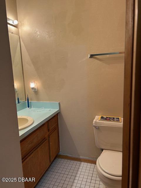 bathroom with tile patterned floors, vanity, and toilet