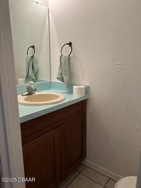 bathroom with tile patterned floors and vanity