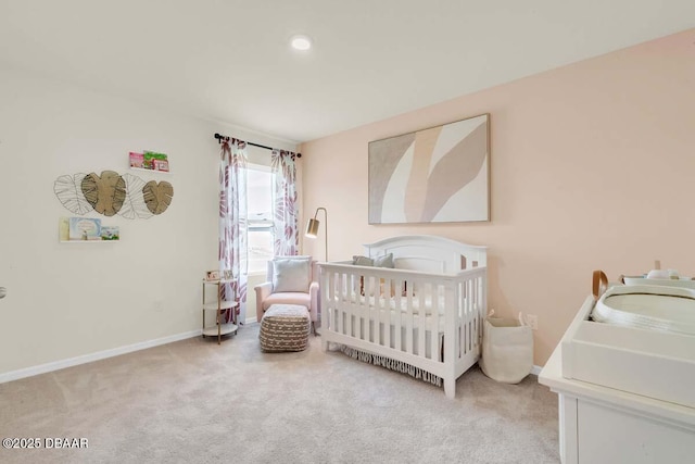 carpeted bedroom with a crib