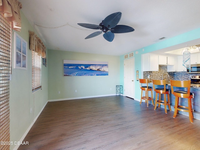2101 N Atlantic Ave Unit 24, Daytona Beach, FL 32118 - living area featuring a ceiling fan, baseboards, visible vents, and wood finished floors