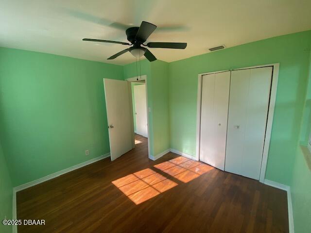 264 Sherwood Ln, Holly Hill, FL 32117 - unfurnished bedroom featuring wood finished floors, a closet, and a ceiling fan