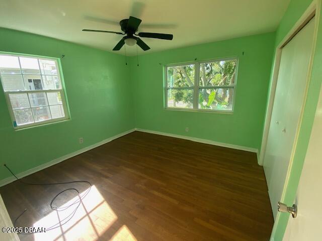 264 Sherwood Ln, Holly Hill, FL 32117 - unfurnished bedroom with dark wood-style floors, a closet, and ceiling fan