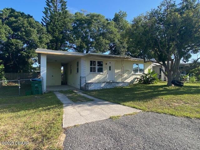 264 Sherwood Ln, Holly Hill, FL 32117 - view of front of home with driveway and an attached carport