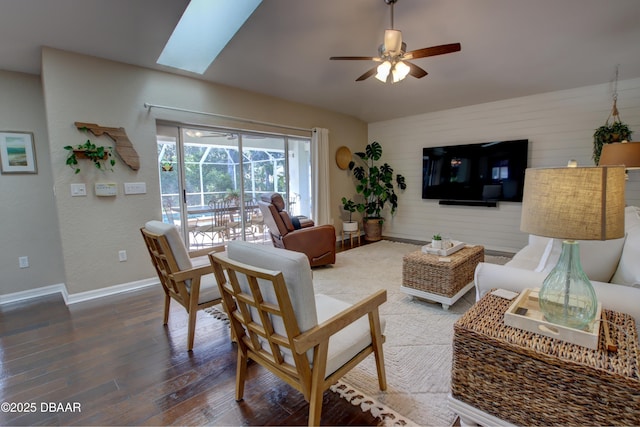 living room with hardwood / wood-style flooring, ceiling fan, and lofted ceiling