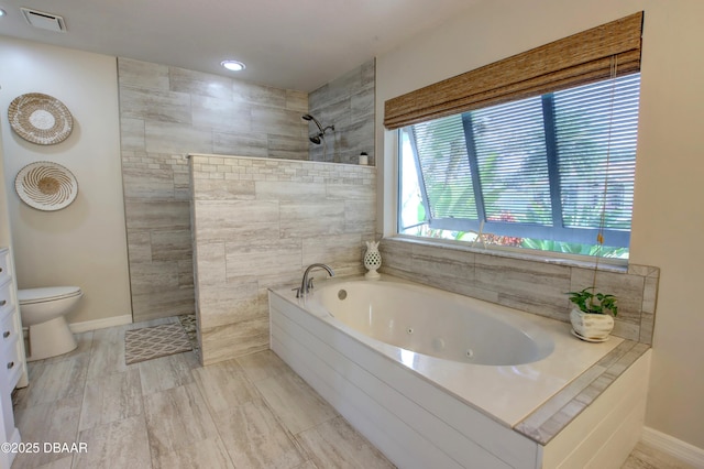 bathroom with shower with separate bathtub and toilet