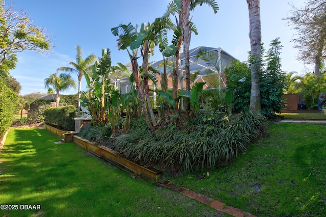 view of yard with glass enclosure