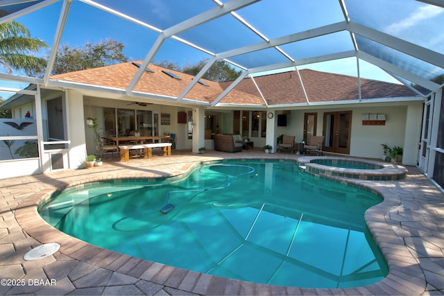 view of pool featuring an in ground hot tub, a lanai, ceiling fan, and a patio area