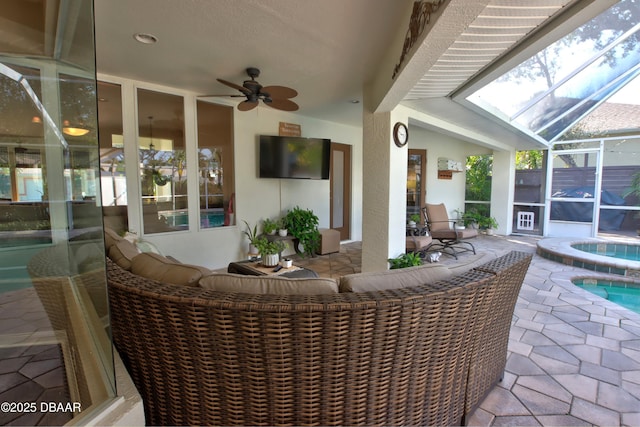 view of patio with an in ground hot tub, a lanai, an outdoor hangout area, and ceiling fan