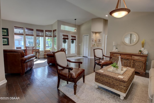 living room with french doors, dark hardwood / wood-style flooring, and high vaulted ceiling