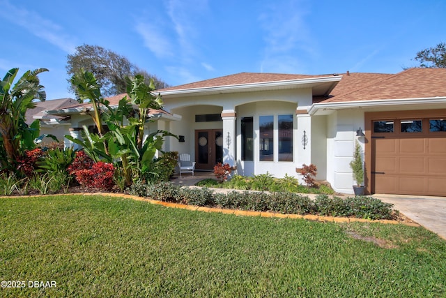 view of front of house with a garage and a front lawn