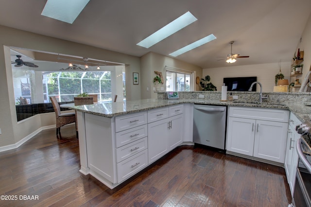 kitchen featuring white cabinetry, stainless steel appliances, sink, and light stone counters