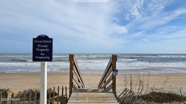 surrounding community with a view of the beach and a water view