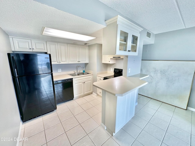 kitchen featuring white cabinets, a textured ceiling, black appliances, and sink