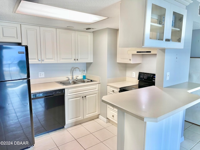 kitchen with black appliances, kitchen peninsula, sink, and white cabinets