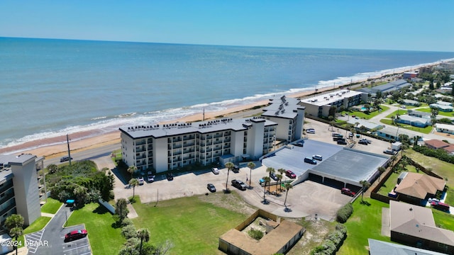 drone / aerial view featuring a water view and a beach view