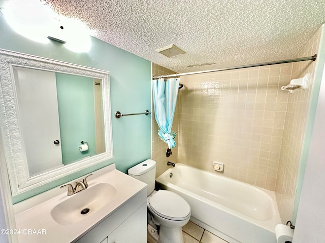 full bathroom featuring shower / bath combination with curtain, vanity, a textured ceiling, tile patterned flooring, and toilet