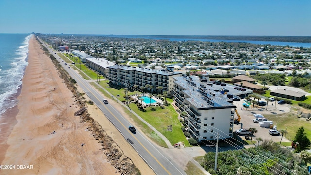 aerial view with a water view and a beach view