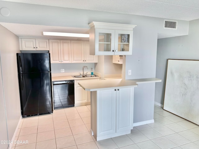 kitchen featuring white cabinets, sink, black appliances, and kitchen peninsula