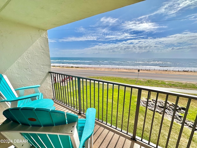 balcony featuring a water view and a view of the beach