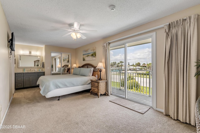 bedroom with ceiling fan, light colored carpet, a textured ceiling, and access to outside