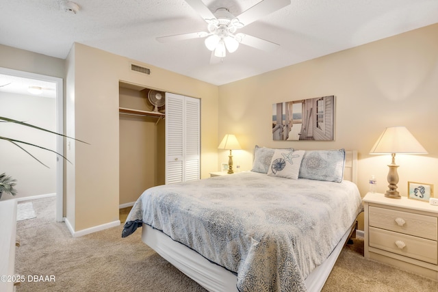 bedroom featuring ceiling fan, a closet, and light carpet