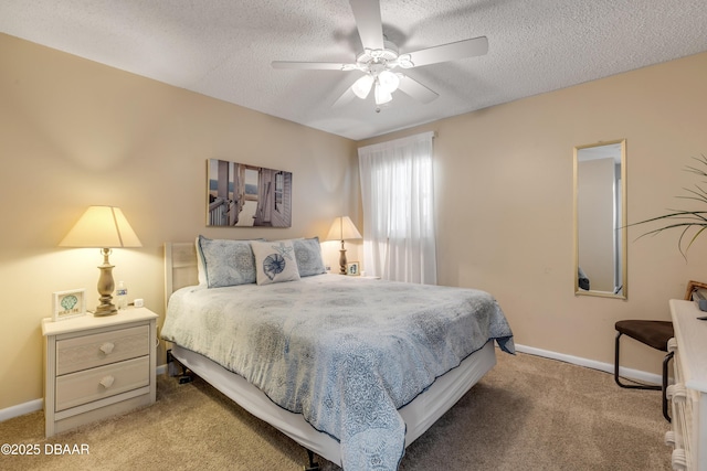 bedroom featuring a textured ceiling, ceiling fan, and light carpet