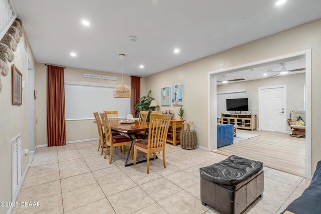 tiled dining space with ceiling fan