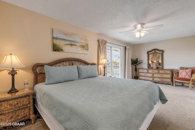 carpeted bedroom featuring ceiling fan, access to exterior, and a textured ceiling