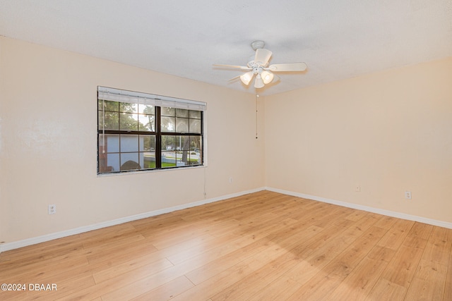 empty room with ceiling fan and light hardwood / wood-style floors