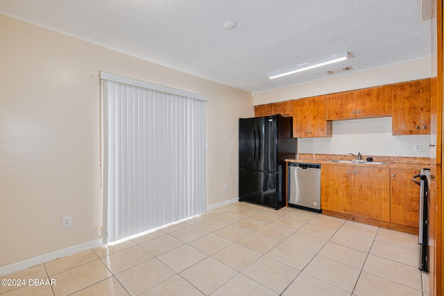 kitchen featuring light tile patterned floors, a textured ceiling, sink, and appliances with stainless steel finishes