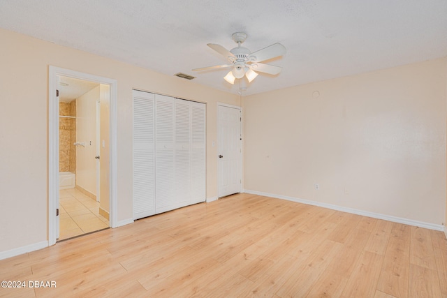 unfurnished bedroom featuring ensuite bathroom, ceiling fan, and light hardwood / wood-style flooring