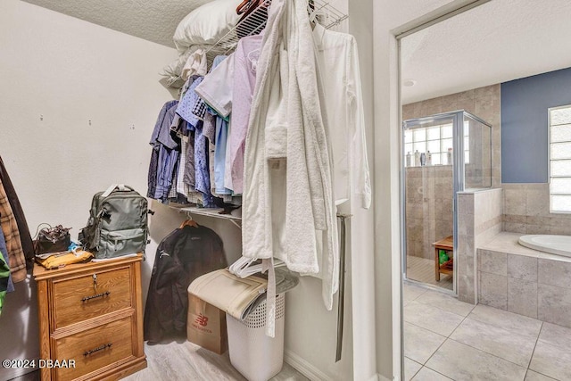 spacious closet featuring light tile patterned floors