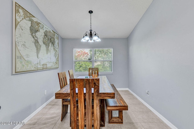 dining area with light tile patterned floors and a chandelier