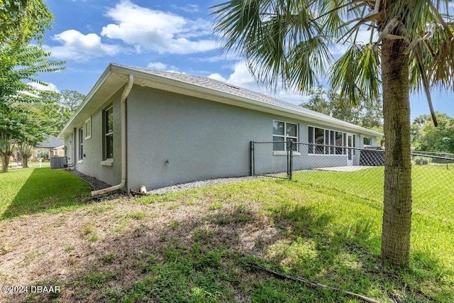 view of home's exterior with a lawn and cooling unit