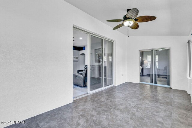 interior space featuring lofted ceiling and ceiling fan