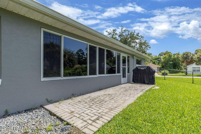 view of home's exterior with a yard and a patio