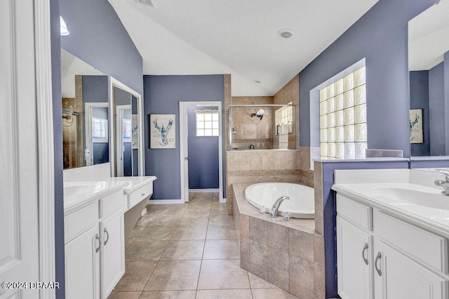 bathroom featuring plus walk in shower, tile patterned flooring, and vanity