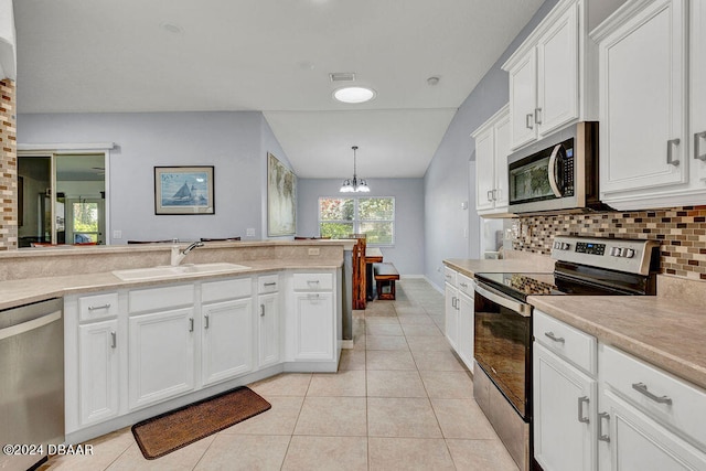 kitchen with white cabinets, lofted ceiling, stainless steel appliances, sink, and light tile patterned flooring