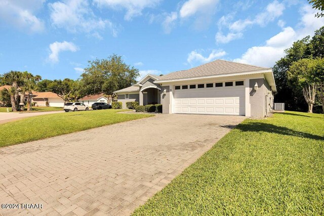 view of front of property featuring central air condition unit, a garage, and a front yard