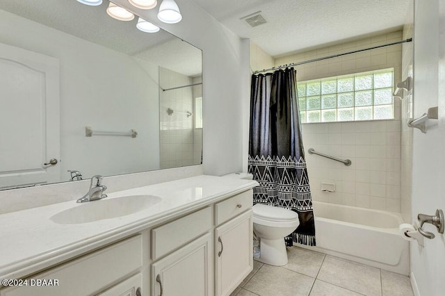 full bathroom featuring a textured ceiling, tile patterned floors, vanity, toilet, and shower / bath combo with shower curtain