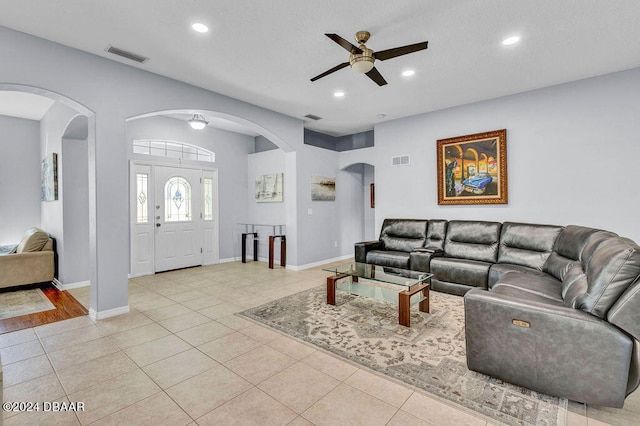 living room with ceiling fan and light tile patterned flooring