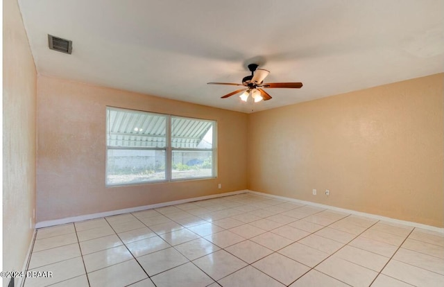 tiled empty room with ceiling fan