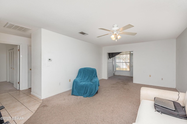 sitting room with light colored carpet and ceiling fan