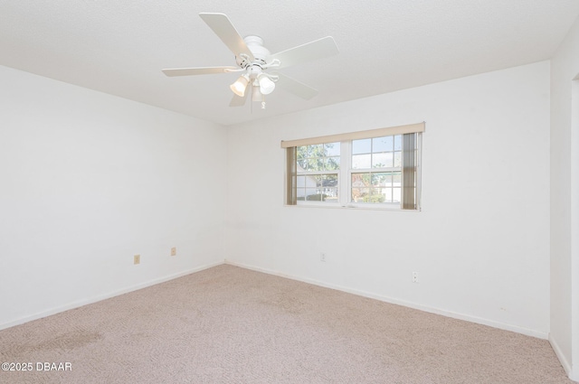 empty room featuring carpet flooring and ceiling fan