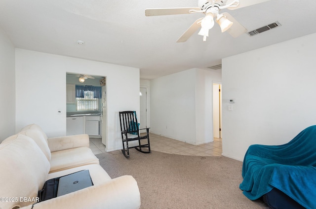 living room featuring light carpet and ceiling fan