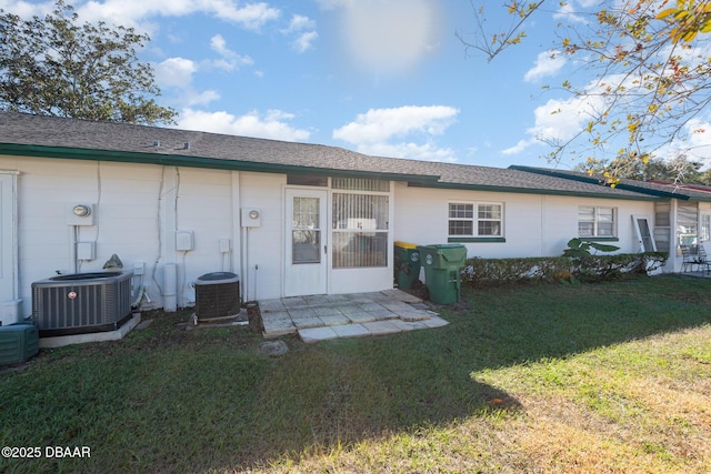 rear view of house featuring a yard and central AC