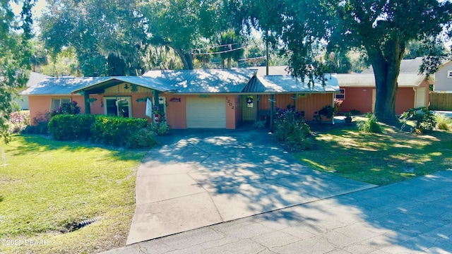 ranch-style house featuring driveway, an attached garage, and a front lawn